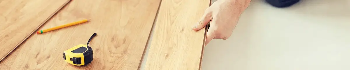 A professional installing wood flooring in Charlotte, NC