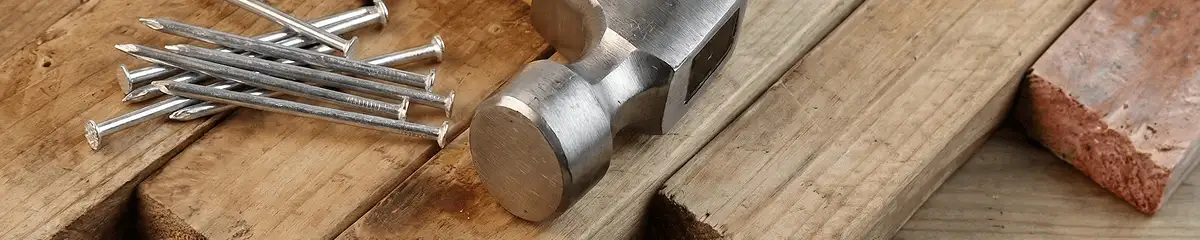 Hammer and nails on hardwood flooring boards in Charlotte, NC