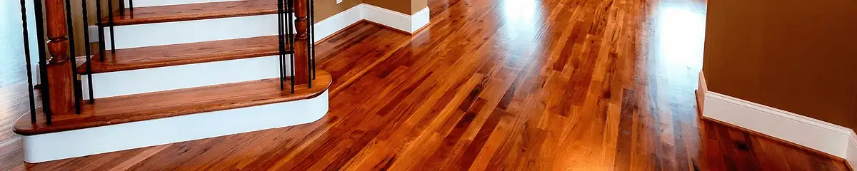 Base floor of a staircase with professionally restored wood flooring in Charlotte NC