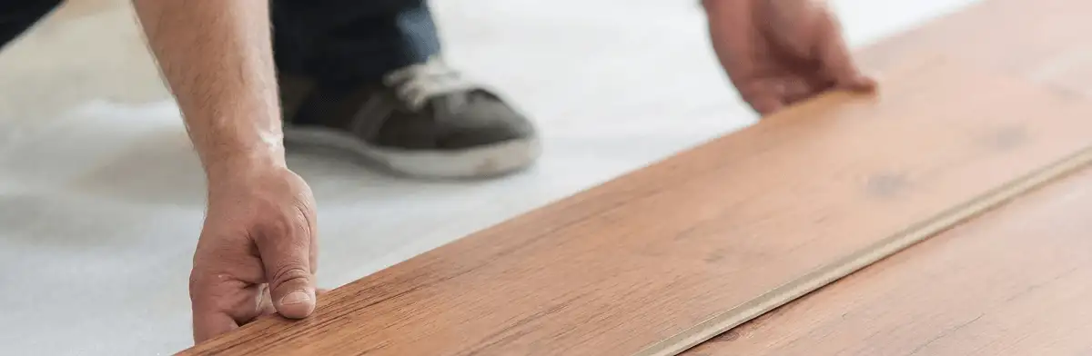 A professional installing laminate flooring in Charlotte, NC