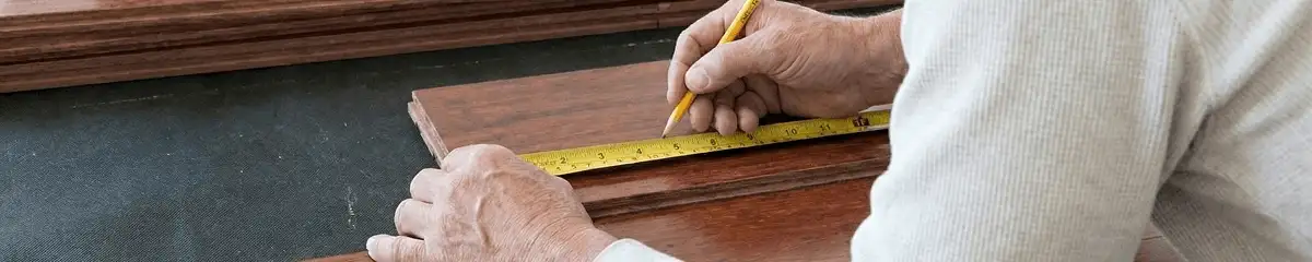 A professional installing wood flooring in Charlotte, NC